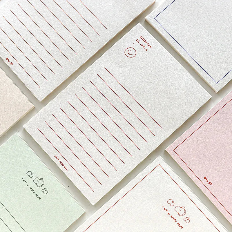 A rectangular memo pad notebook with a choice of paper cover designs, shown open to reveal blank or lined writing pages.