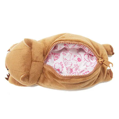 Brown plush wombat cartoon animal pencil case with zip, shown next to pens and pencils.