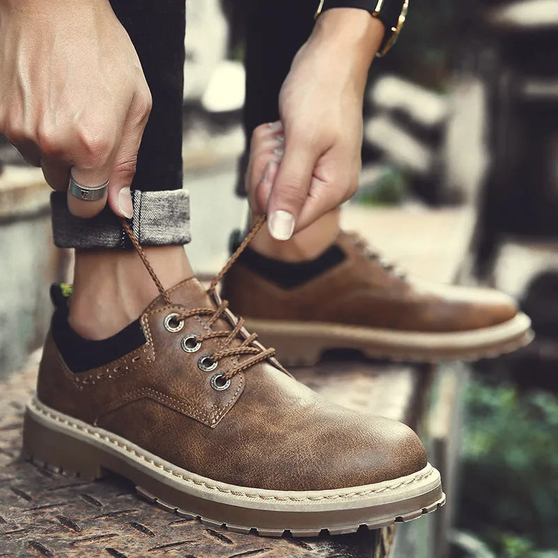 Men's black casual shoes with round toe, front lace-up, and flat rubber sole on a neutral background