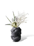 Ceramic flower vase with irregular concave-convex surface in white, 26x25x34cm, on a wooden table