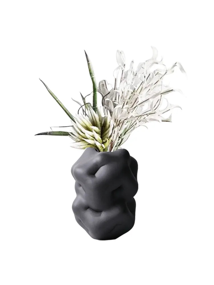 Ceramic flower vase with irregular concave-convex surface in white, 26x25x34cm, on a wooden table