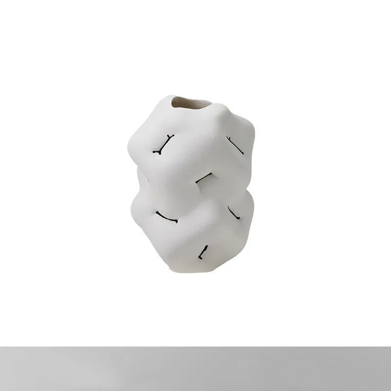 Ceramic flower vase with irregular concave-convex surface in white, 26x25x34cm, on a wooden table