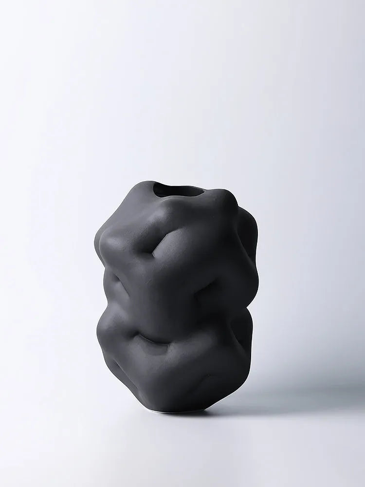 Ceramic flower vase with irregular concave-convex surface in white, 26x25x34cm, on a wooden table