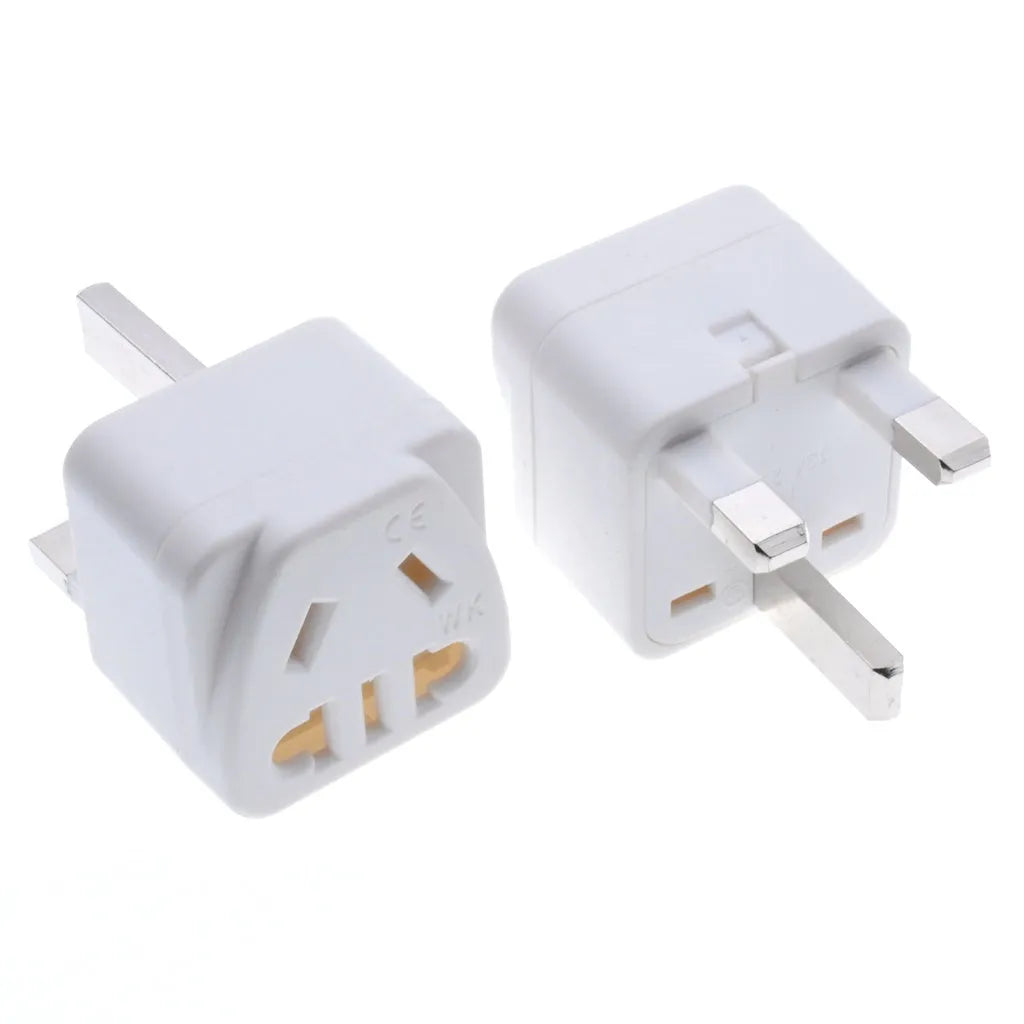 White and black UK three-pin to international power conversion adapter with grounding pins