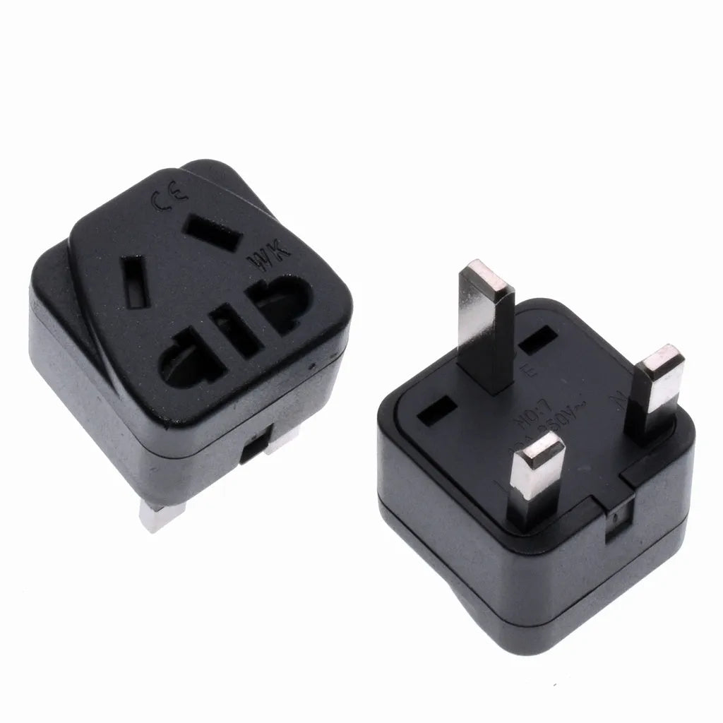 White and black UK three-pin to international power conversion adapter with grounding pins