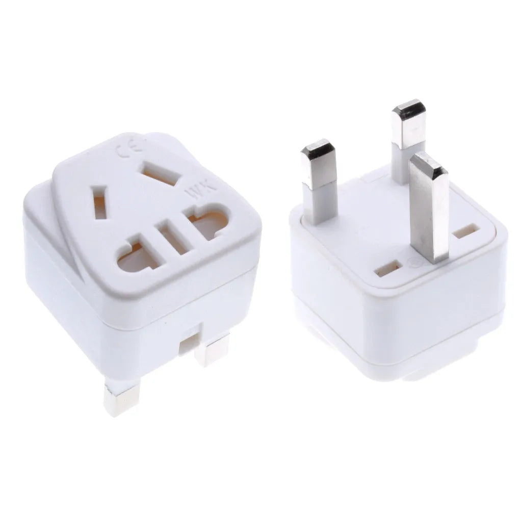 White and black UK three-pin to international power conversion adapter with grounding pins