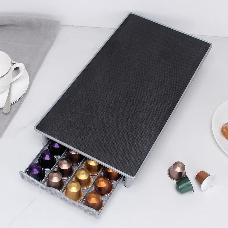 Iron coffee capsule drawer holder in sprayed silver grey on a kitchen worktop
