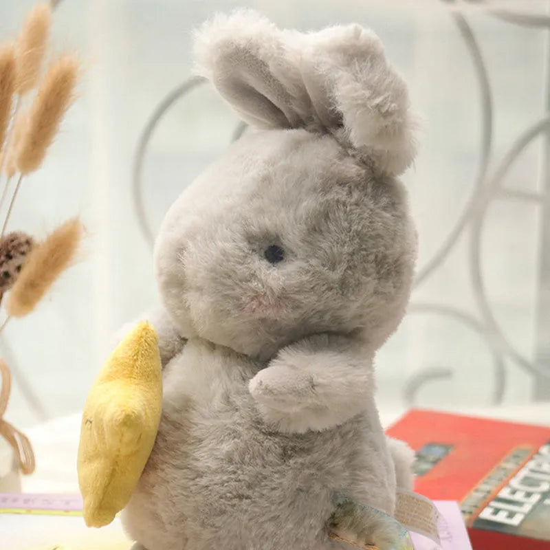 Soft fluffy angora rabbit plush toy in grey with carrot design, 23cm tall on white background
