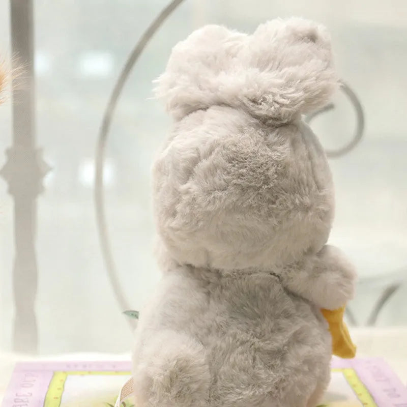 Soft fluffy angora rabbit plush toy in grey with carrot design, 23cm tall on white background