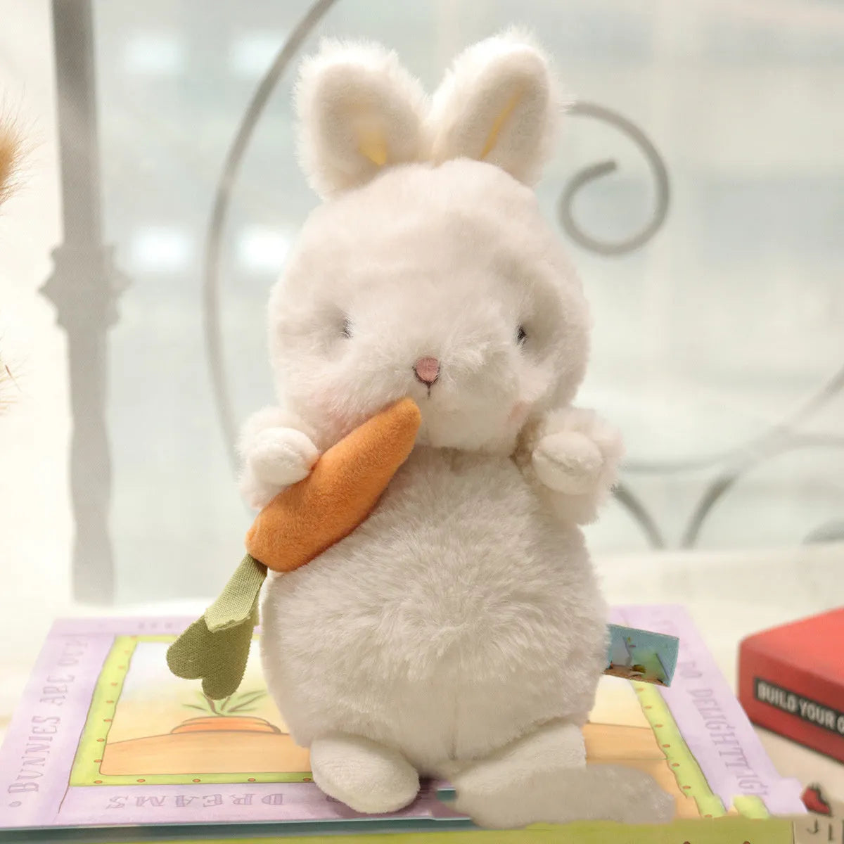 Soft fluffy angora rabbit plush toy in grey with carrot design, 23cm tall on white background