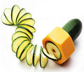 Yellow and green plastic spiral vegetable cutter and cucumber slicer kitchen gadget.