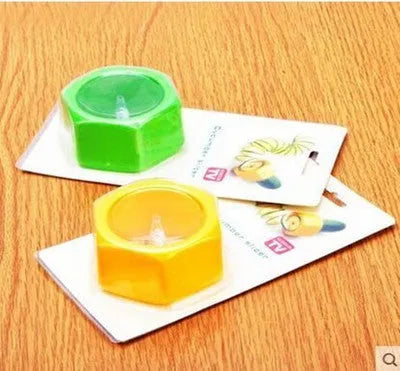 Yellow and green plastic spiral vegetable cutter and cucumber slicer kitchen gadget.