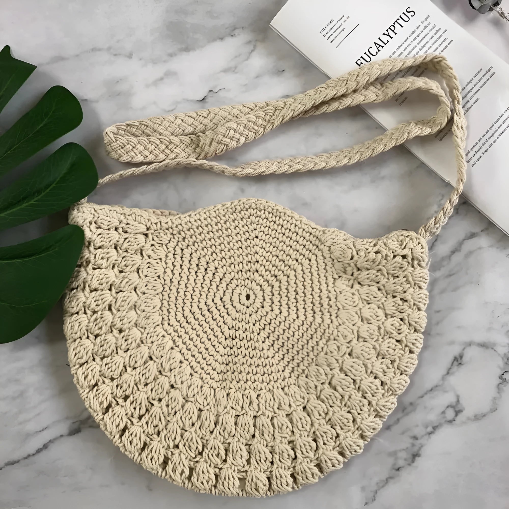 Women's woven dumpling messenger bag in brown, medium size, with single strap and zipper closure