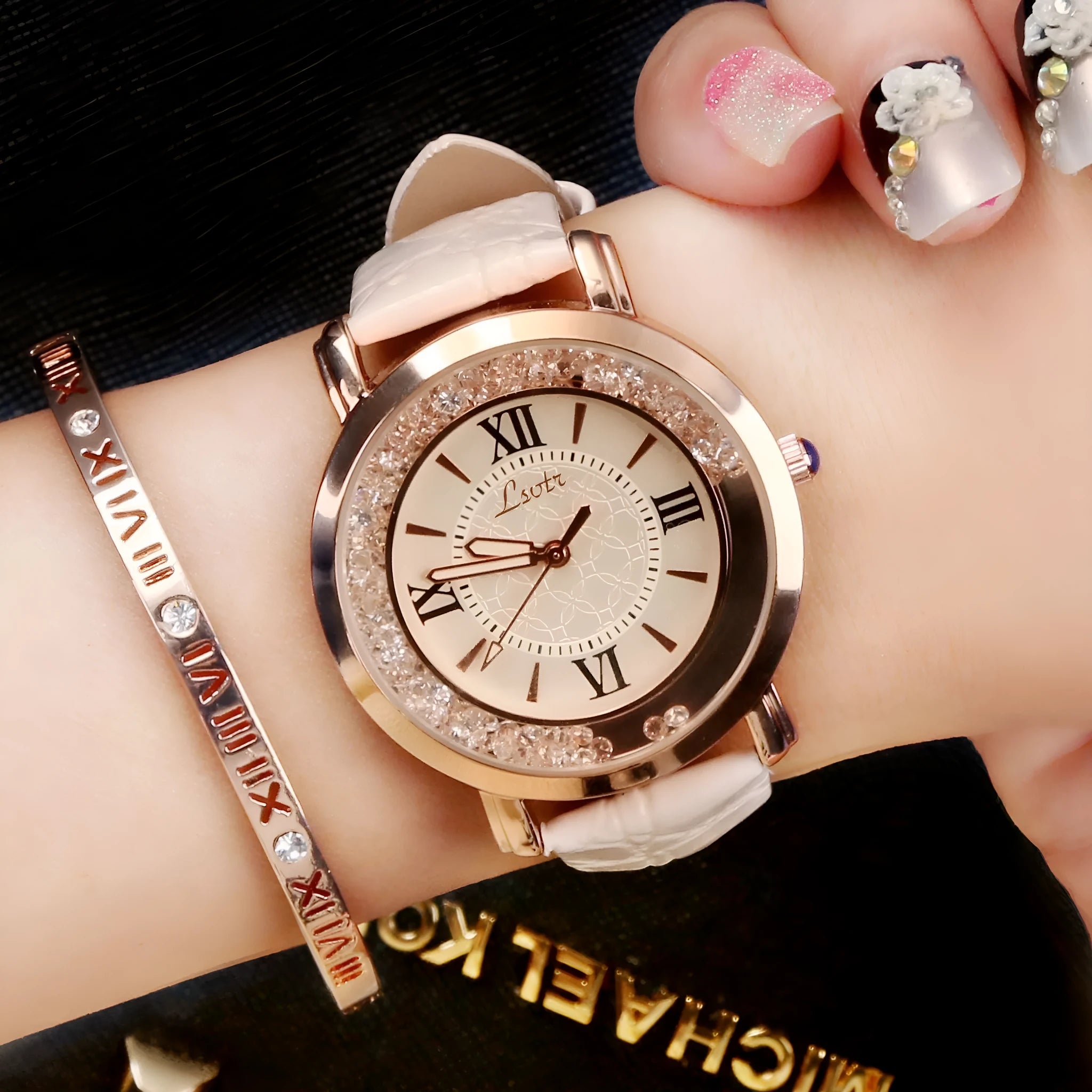 Ladies round metal case watch with white dial, rhinestone crown, and brown PU strap