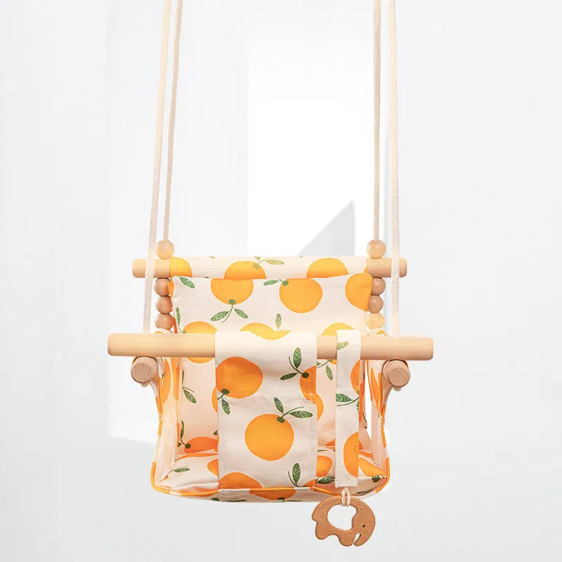 Cotton canvas baby swing chair with wooden seat and cushion hanging indoors