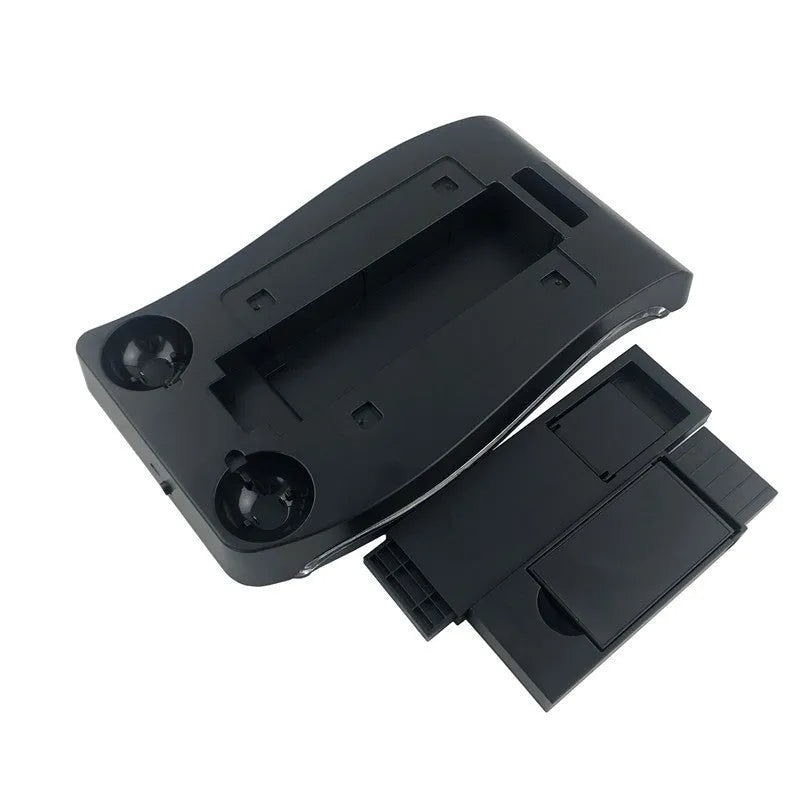 Black ABS plastic charging base for PS4 VR controllers on a surface.