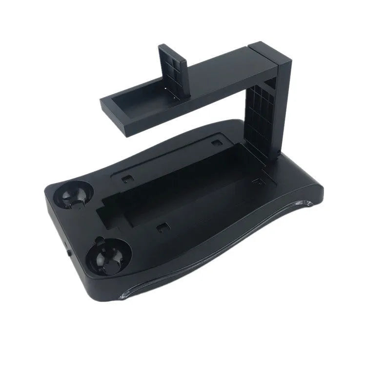 Black ABS plastic charging base for PS4 VR controllers on a surface.