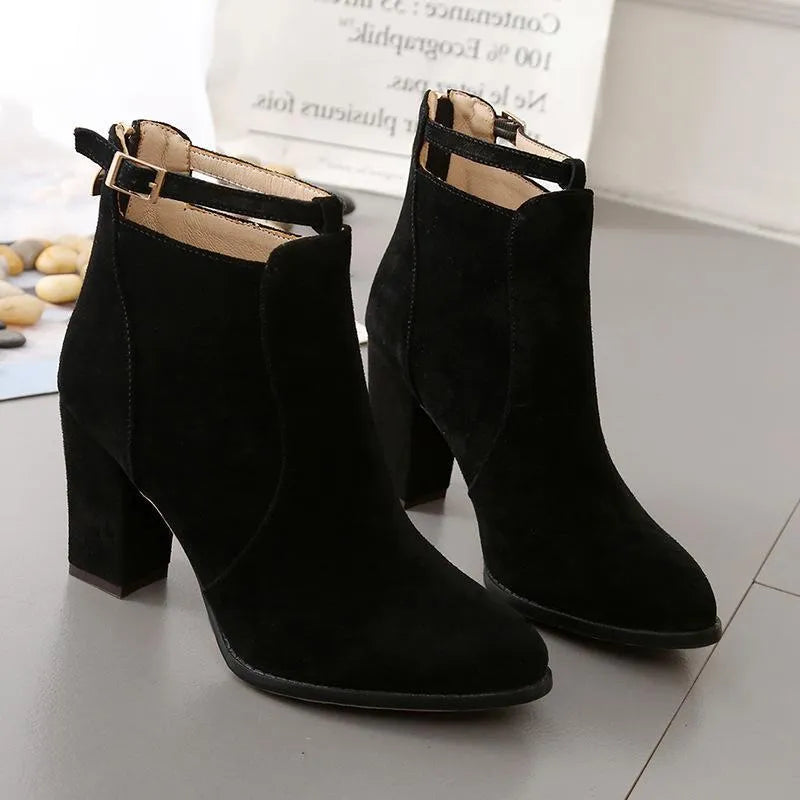 Women's high-heeled Martin boots in black with belt buckle detail, low tube, round toe, and faux fur lining
