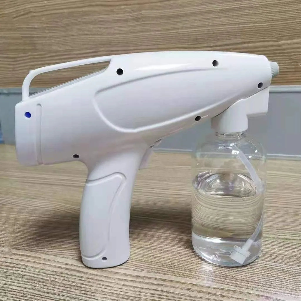 White handheld wireless electric spray disinfection gun with USB-C port and bottle attached