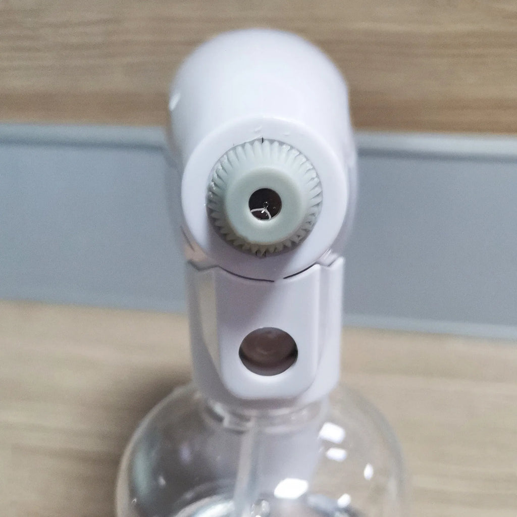 White handheld wireless electric spray disinfection gun with USB-C port and bottle attached