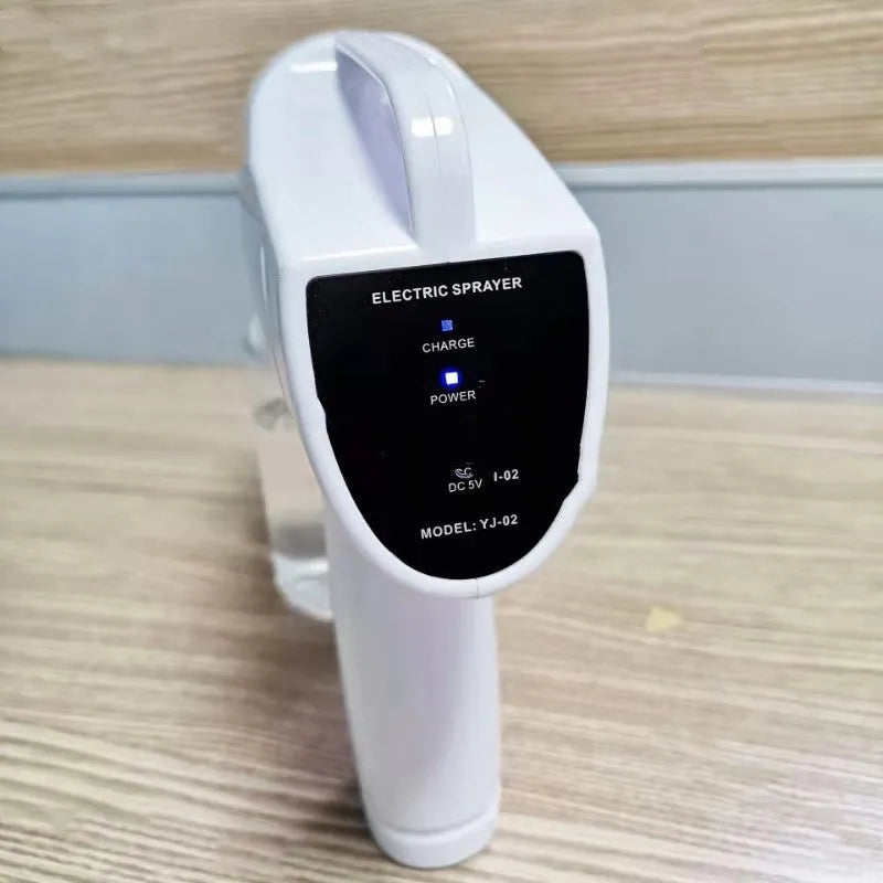 White handheld wireless electric spray disinfection gun with USB-C port and bottle attached