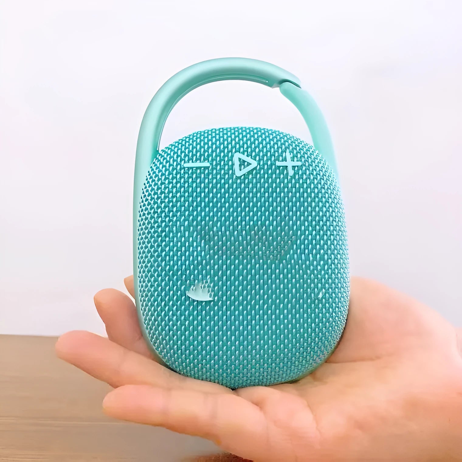 Compact portable Bluetooth speaker in one of six colours: pink, blue, black, red, silver grey, or green.