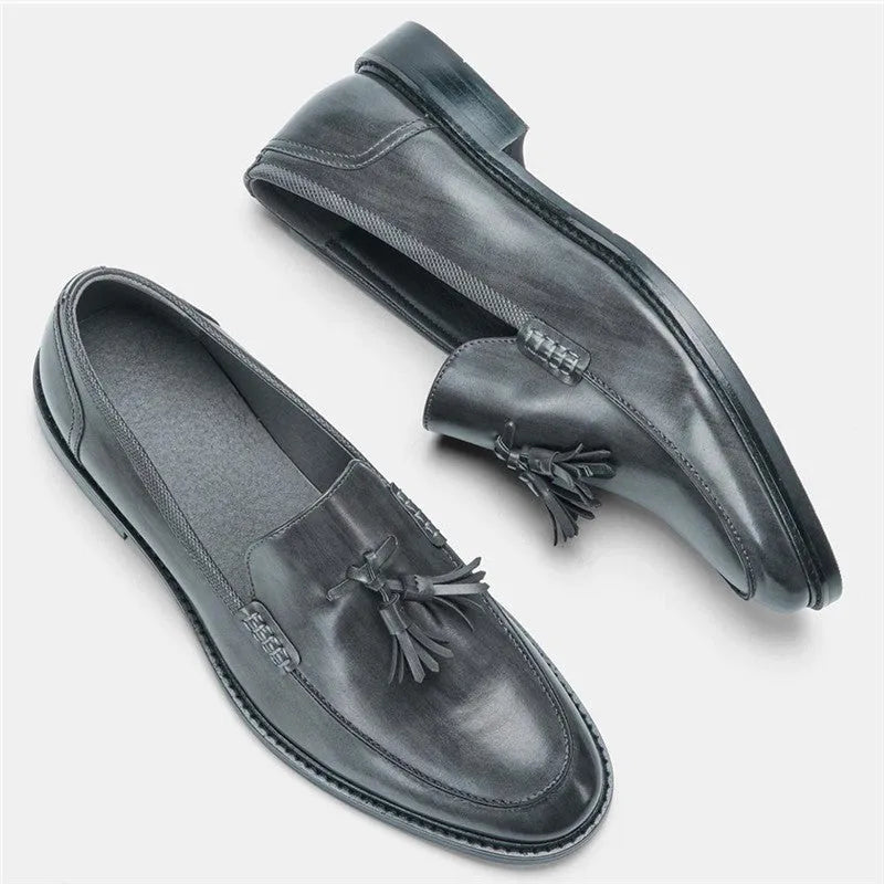 Brown PU leather men's loafers with tassel detail on a round toe, low-cut profile, grey background