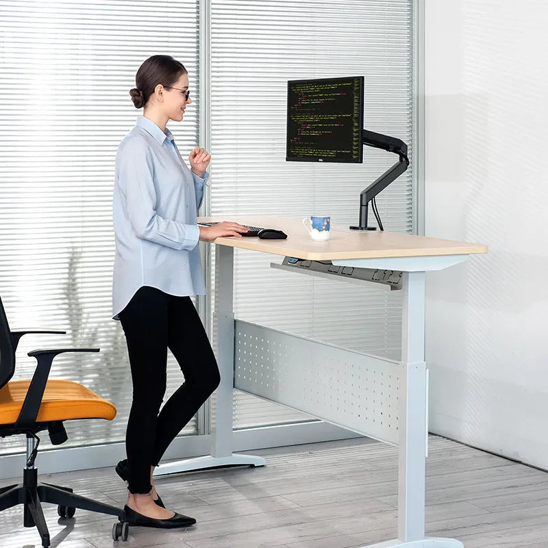 Adjustable lifting computer stand in dark grey supporting a monitor on a desk