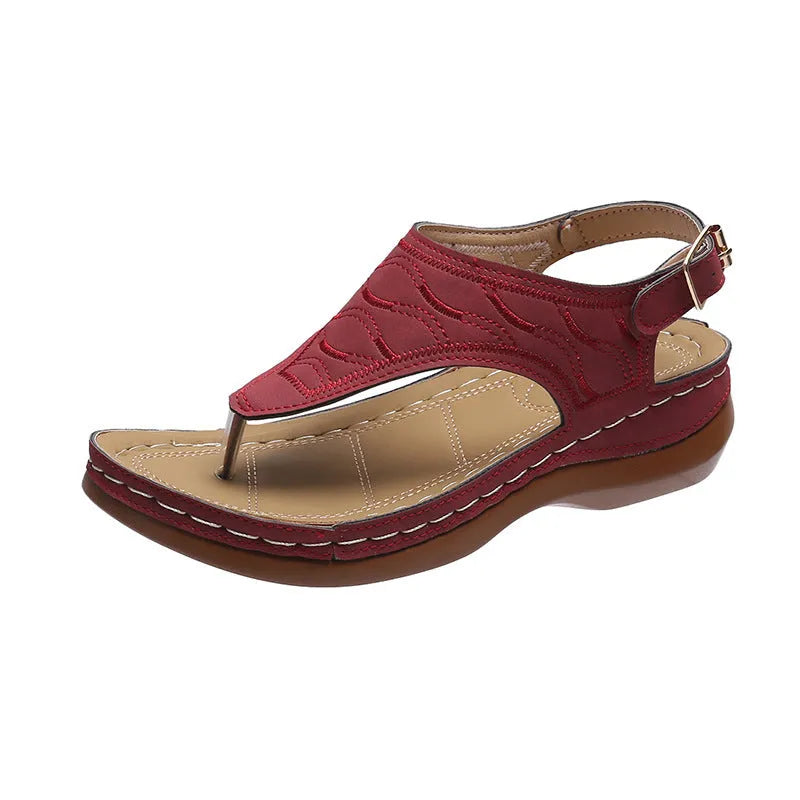 Women's casual wedge heel flip flop sandal in black with adjustable buckle strap.