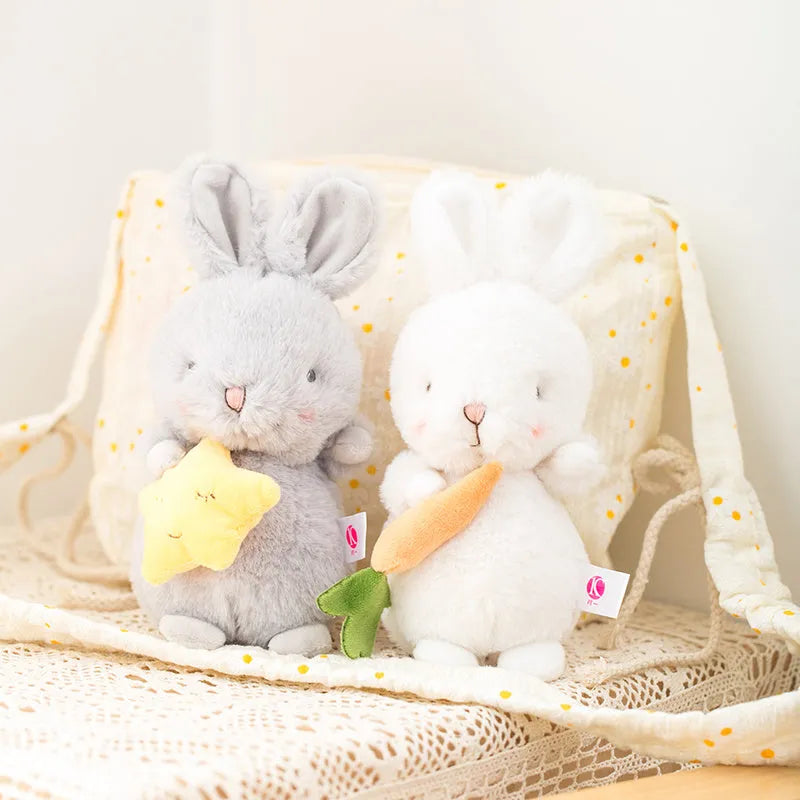 Soft fluffy angora rabbit plush toy in grey with carrot design, 23cm tall on white background