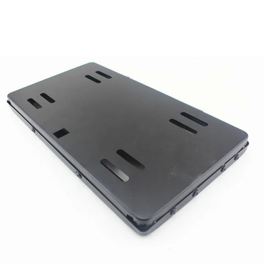 Black flipping licence plate frame made of iron and plastic measuring 314 by 169 millimetres, suitable for US standard plates