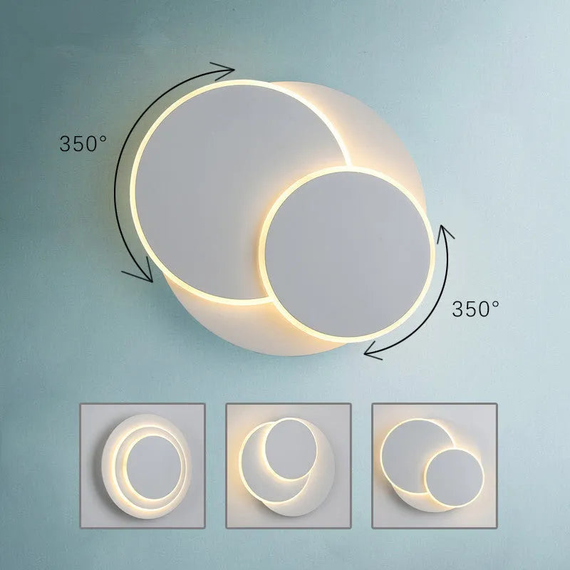 Modern round acrylic LED wall lamp in black or white, shown in small, medium, and large size options.
