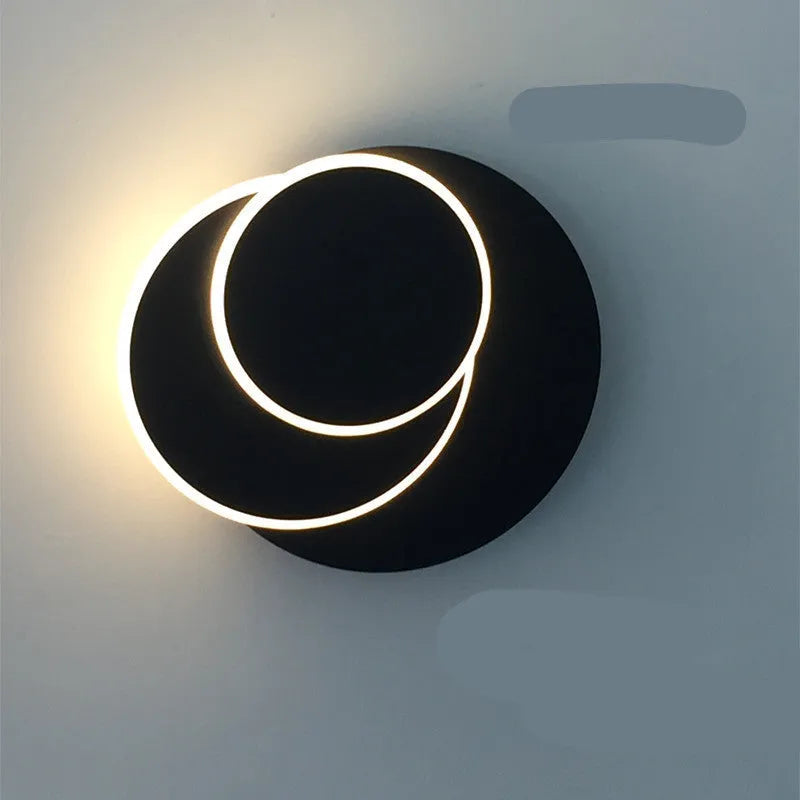 Modern round acrylic wall lamp in black or white, shown in small, medium and large sizes.
