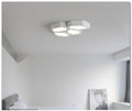 Modern geometric shaped LED wall light in black or white iron frame with remote control.