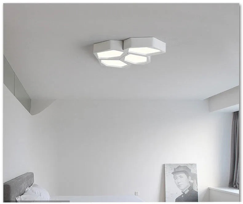 Modern geometric shaped LED wall light in black or white iron frame with remote control.