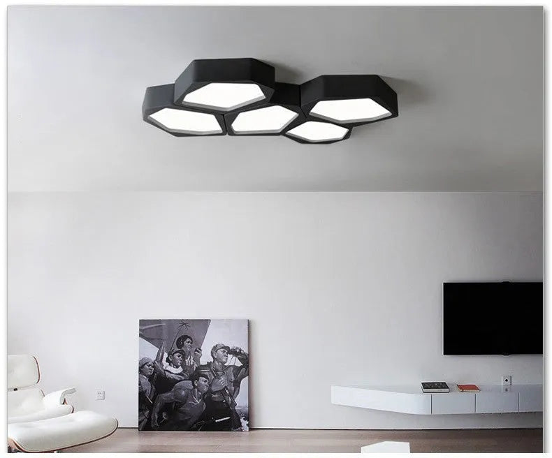 Geometric shaped black iron LED pendant light with remote control for dimming and colour temperature adjustment.