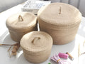 Japanese-style linen fabric storage basket with a cover on a tabletop, shown in three sizes.
