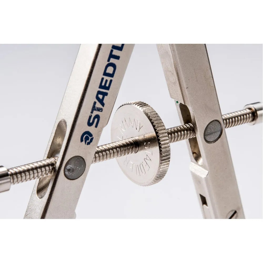 STAEDTLER 551 01 steel car compass with extended telescopic rod on drafting paper.
