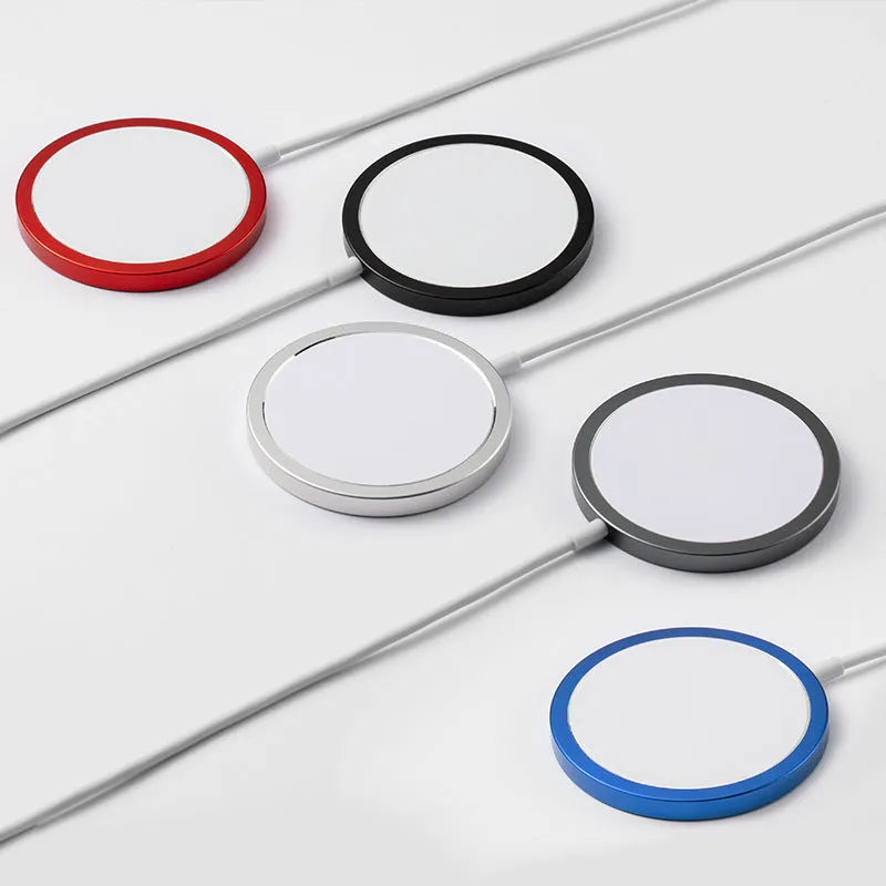 Silver metal Magsafe-compatible magnetic wireless charger for iPhone on a wooden desk.