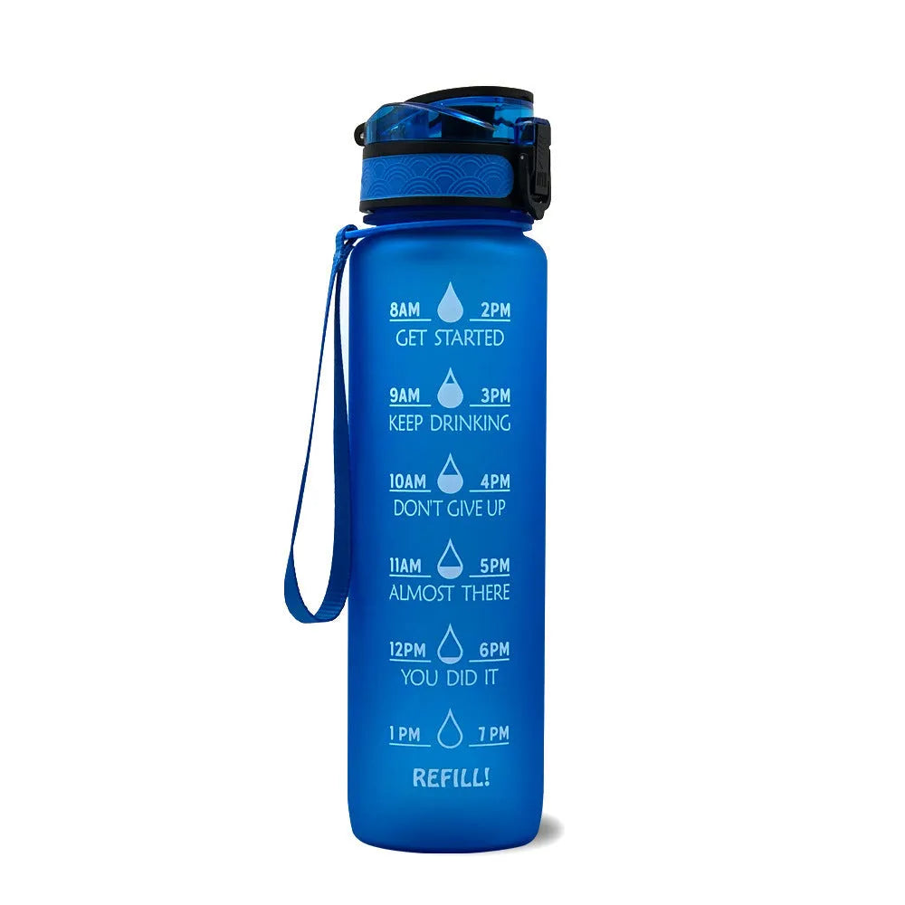 Blue-red gradient 1L Tritan water bottle with time markers and flip-top lid on a gym bag