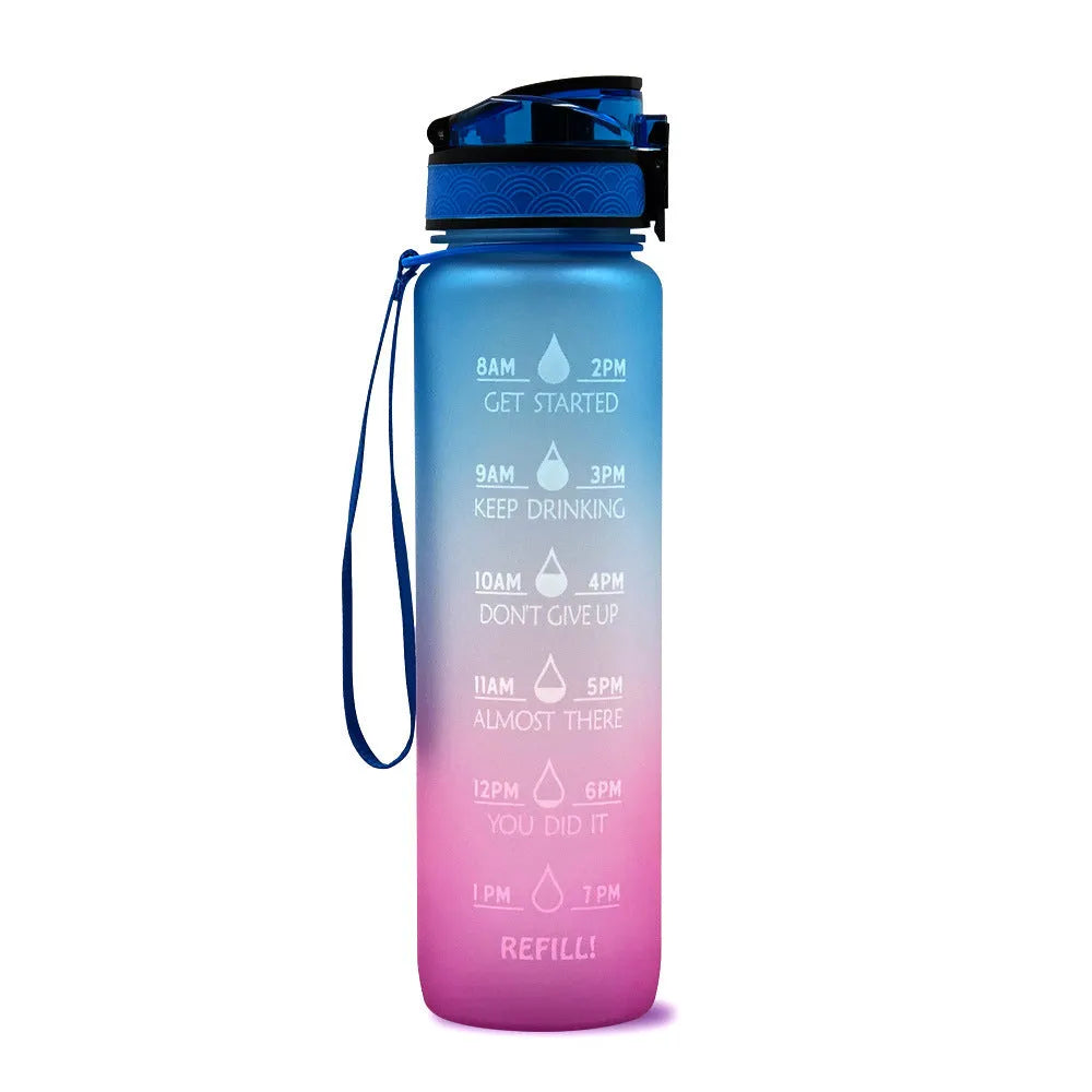Blue-red gradient 1L Tritan water bottle with time markers and flip-top lid on a gym bag