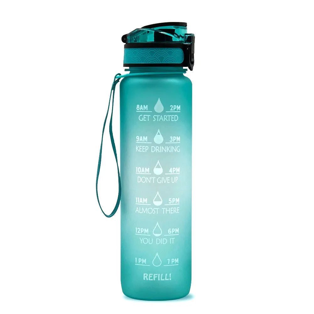 Blue-red gradient 1L Tritan water bottle with time markers and flip-top lid on a gym bag
