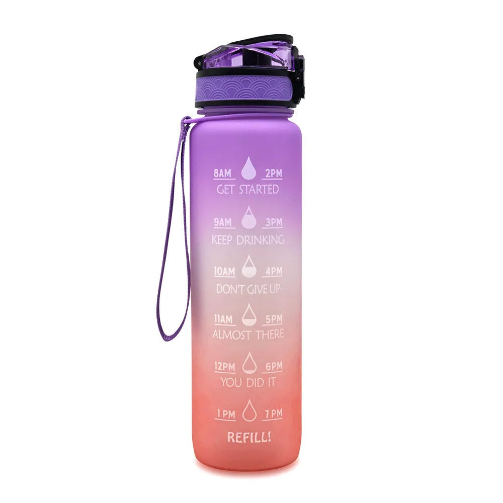 Blue-red gradient 1L Tritan water bottle with time markers and flip-top lid on a gym bag