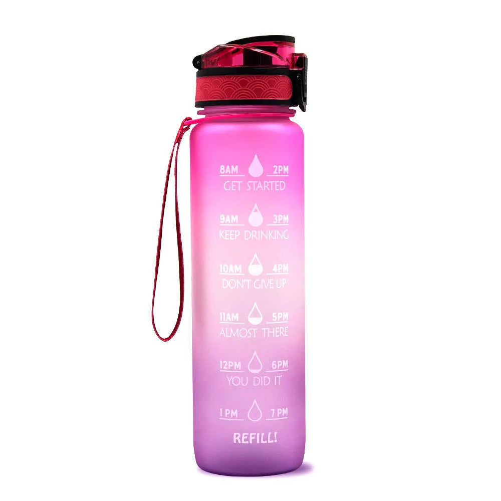 Blue-red gradient 1L Tritan water bottle with time markers and flip-top lid on a gym bag