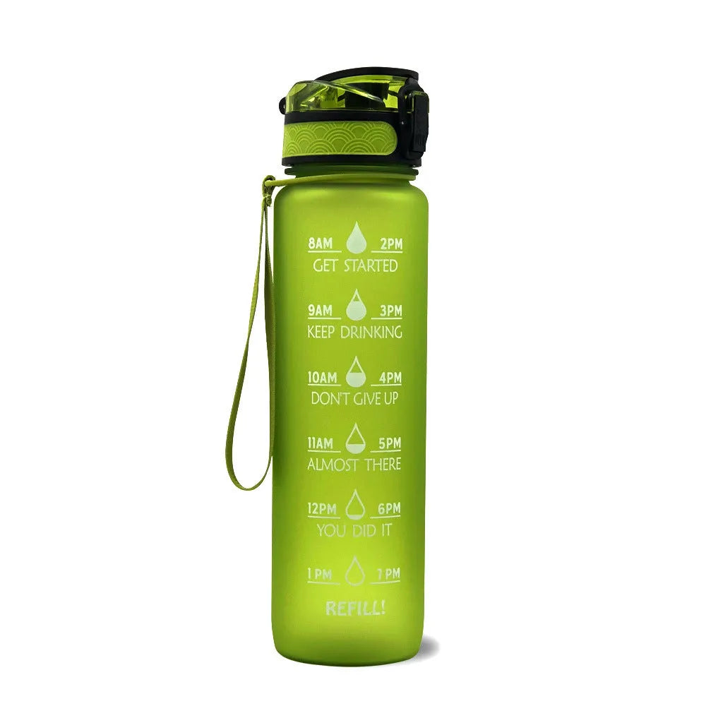 Blue-red gradient 1L Tritan water bottle with time markers and flip-top lid on a gym bag