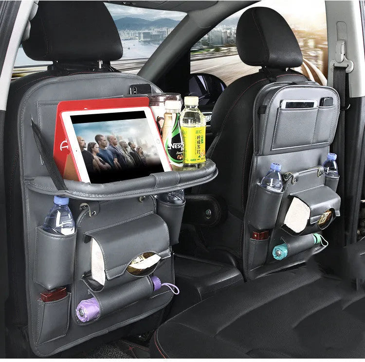 Black PU leather car seat organiser with multiple pockets hanging on a car headrest