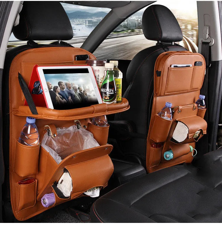 Black PU leather car seat organiser with multiple pockets hanging on a car headrest