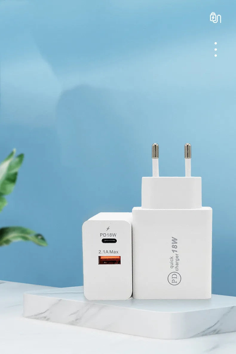 Compact white 18W USB-C fast wall charger with US plug pins on a wooden surface.