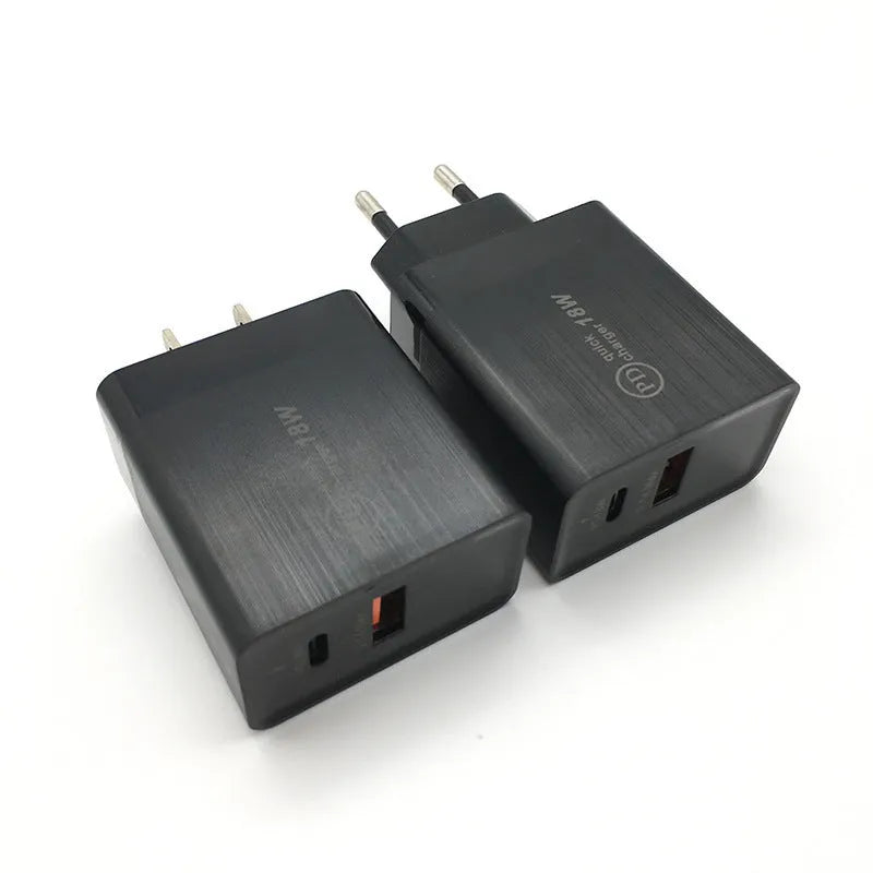 Compact white 18W USB-C fast wall charger with US plug pins on a wooden surface.