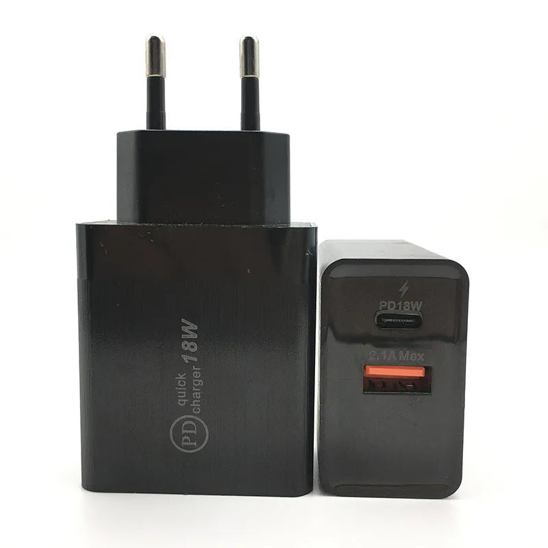 Compact white 18W USB-C fast wall charger with US plug pins on a wooden surface.